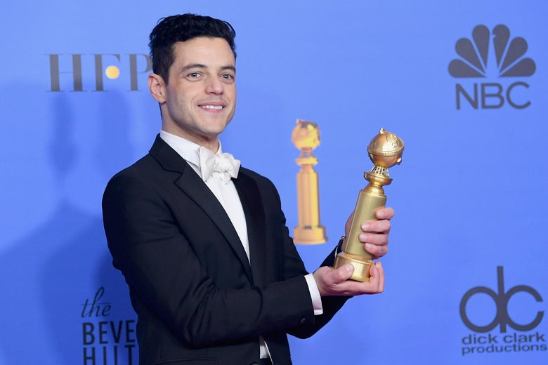 Rami Malek holding a Golden Globe.